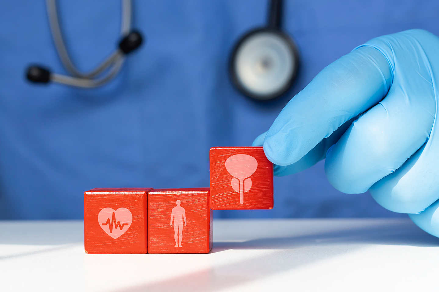 Doctor arranging blocks with prostate and health icons to represent surgical treatment for enlarged prostate