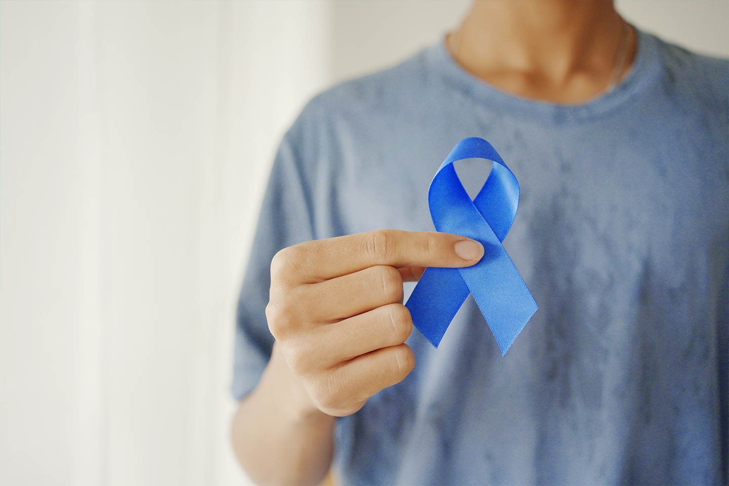 man holding ribbon, representing prostate cancer awareness