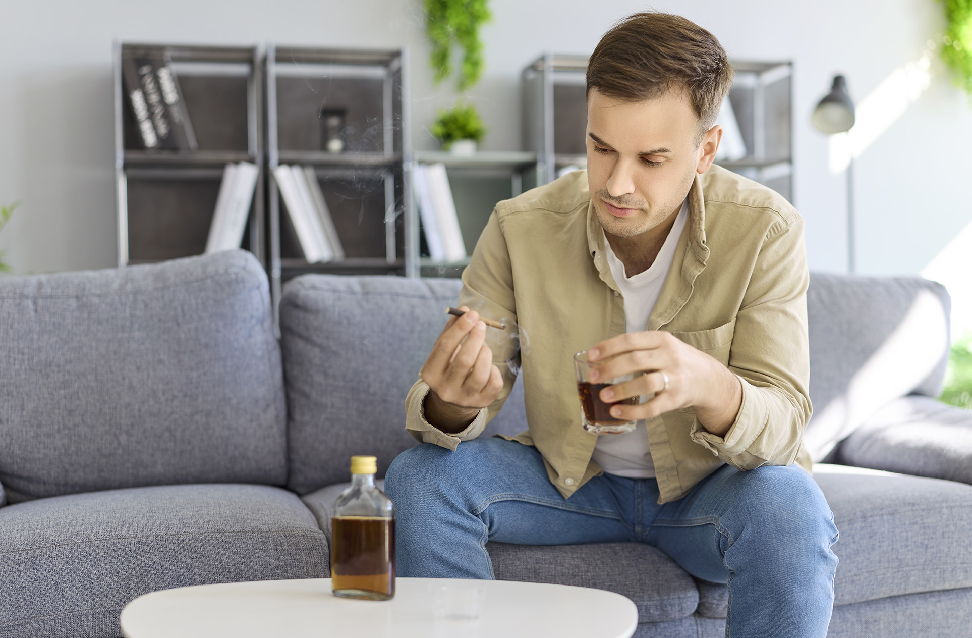 Conceptual image of a man smoking and consuming alcohol