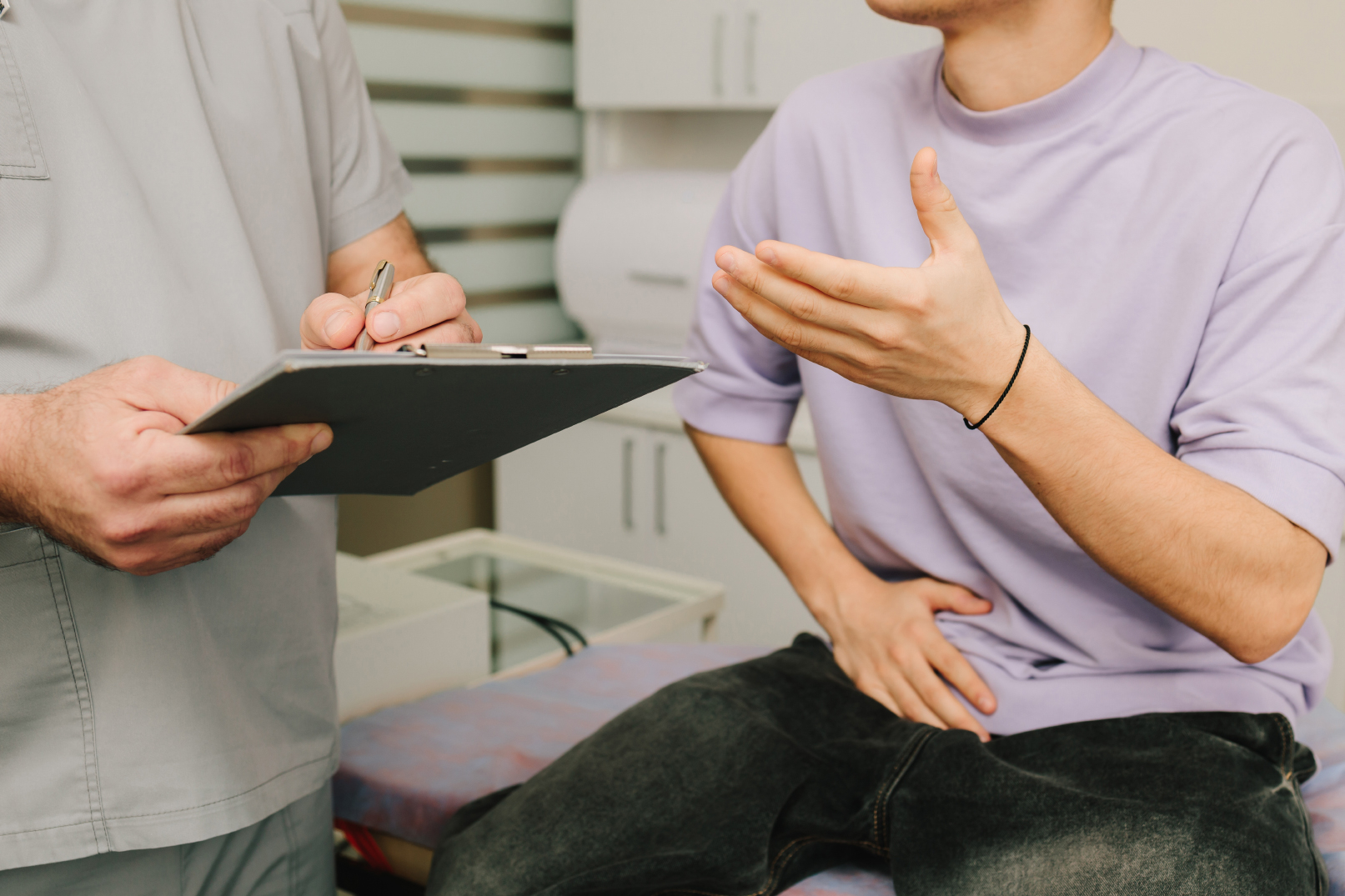 Patient explaining symptoms to male infertility doctor during assessment